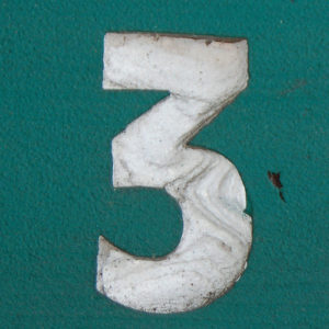 white number 3 against teal background