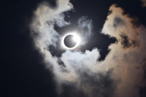 solar eclipse totality with cloud halo