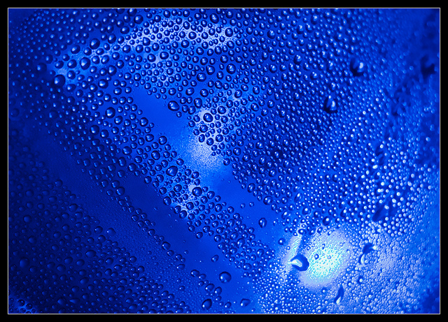 blue surface with condensation droplets coating it.
